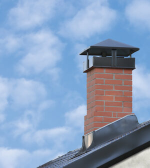 A Red Brick Chimney Atop a Gray Steel Tiled Roof of a House Glen Burnie, Baltimore, MD