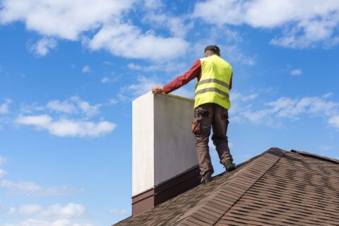 The man fixing the chimney in top of house at Maryland